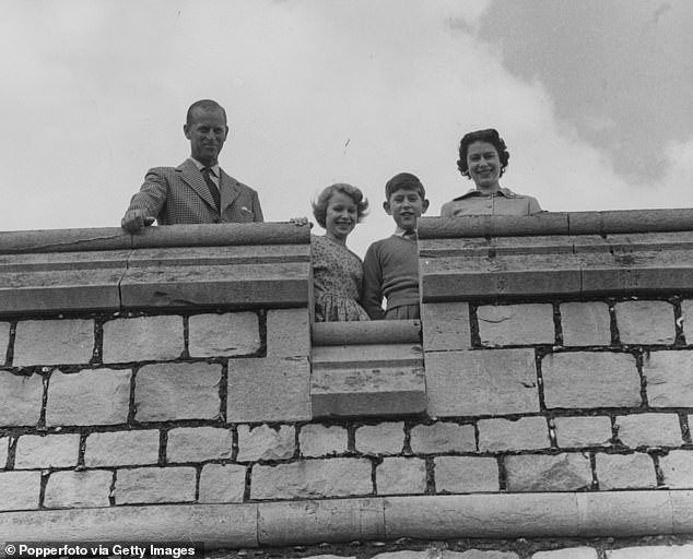 Duke of Edinburgh, Princess Anne, Prince Charles and Queen Elizabeth II, pictured looking down from the east terrace wall of Windsor Castle in 1959