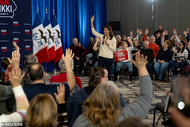 Republican presidential candidate and former U.S. Ambassador to the United Nations Nikki Haley asks new attendees to raise their hands during a campaign town hall in Cedar Falls, Iowa