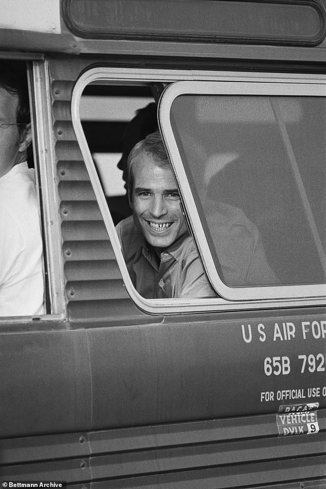 McCain smiling from a bus window upon arrival at Clark Air Base, Philippines, following his release from Hanoi during the Vietnam War, March 14, 197