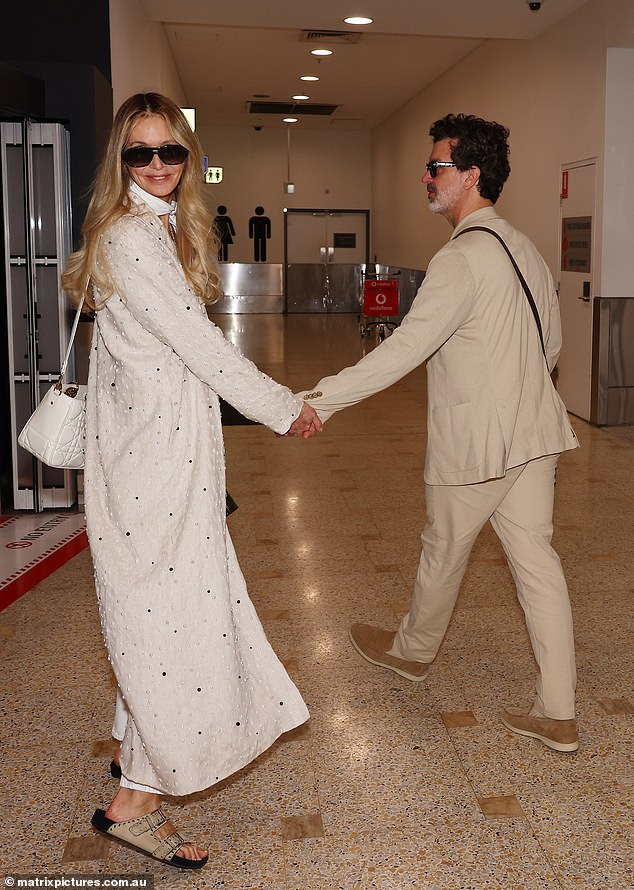 She paired her look with a matching scarf and black sunglasses