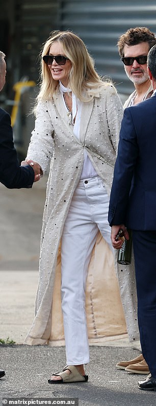 Elle seemed cheerful as she greeted several airport employees before boarding her waiting limo