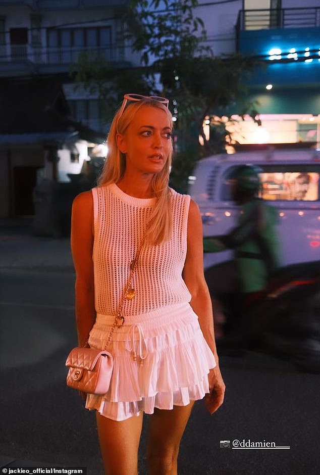 Jackie 'O' showed off her slim figure during the meal in a sleeveless top paired with a white mini skirt