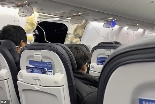 Oxygen masks dangle from the ceiling of the plane as the dark night is seen from inside the plane from the giant gaping hole left behind