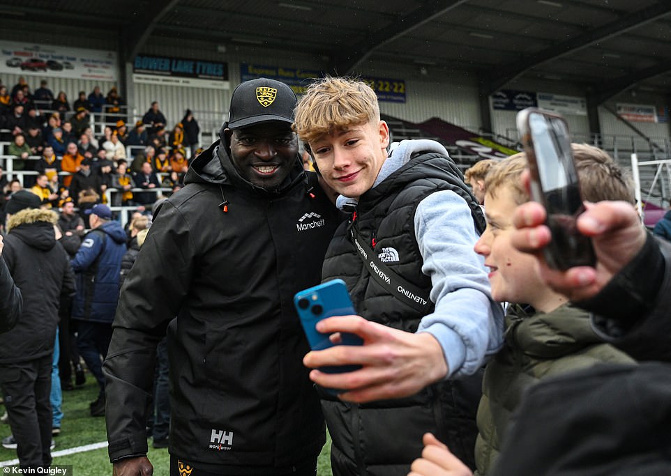 Manager George Elokobi took photos alongside scores of jubilant supporters long after the final whistle had blown