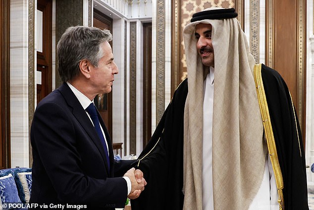 Emir Sheikh Tamim bin Hamas al-Thani of Qatar shakes hands with Blinken during a round of strategic talks on the topic of the Israel-Gaza war