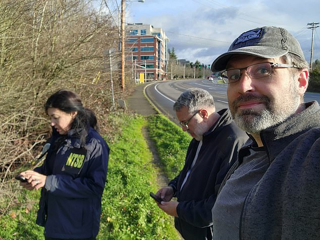 Sean Bates, pictured here with NTSB investigators, said he was told his find was the second cell phone from the flight found by a member of the public