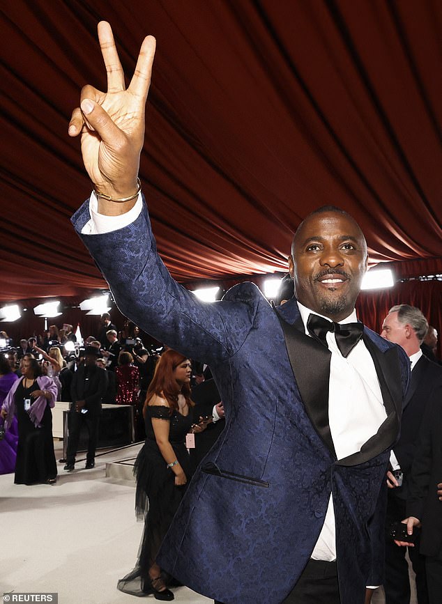 Idris Elba poses on the champagne red carpet during the Oscars arrival at the 95th Academy Awards in Hollywood, 2023