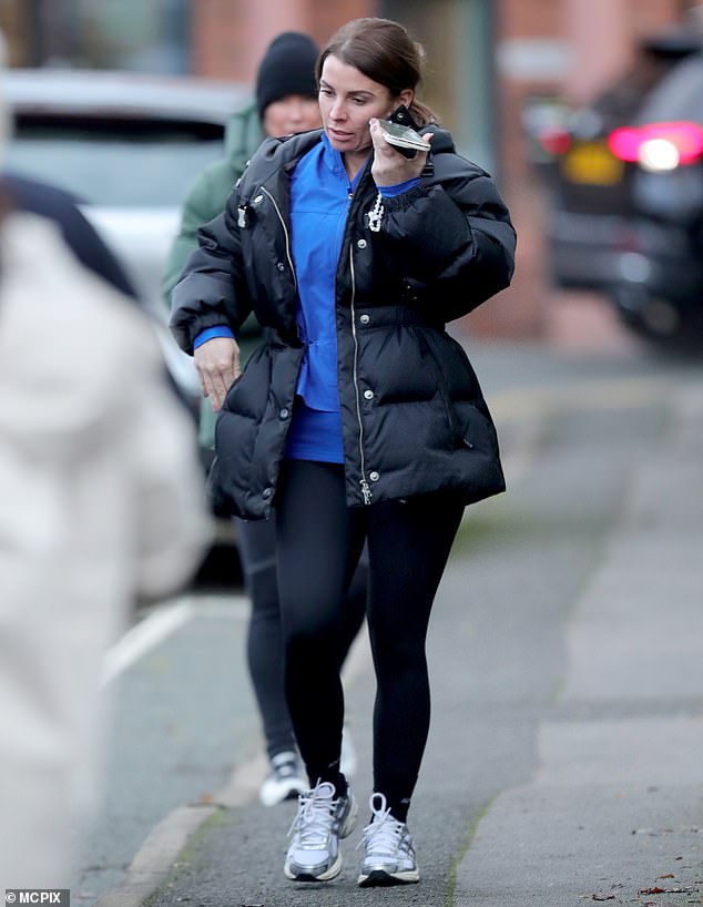 The TV personality wore a cobalt blue zip-up jacket underneath and paired her workout ensemble with cozy white sneakers