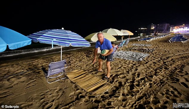 In Benidorm, locals were seen setting up umbrellas in front of the ocean in the dark as they battled the British who swarmed to the sunbeds