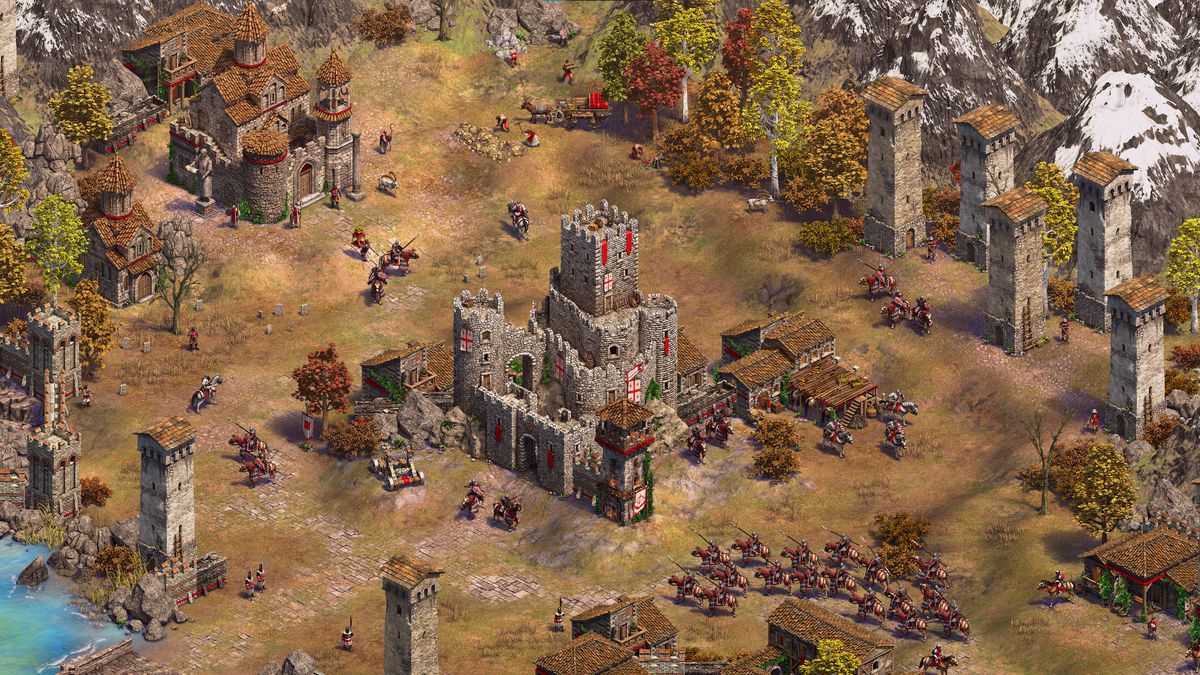 A small cavalry army approaches the castle at the center of a base in Age of Empires 2: Definitive Edition's Mountain Royals expansion