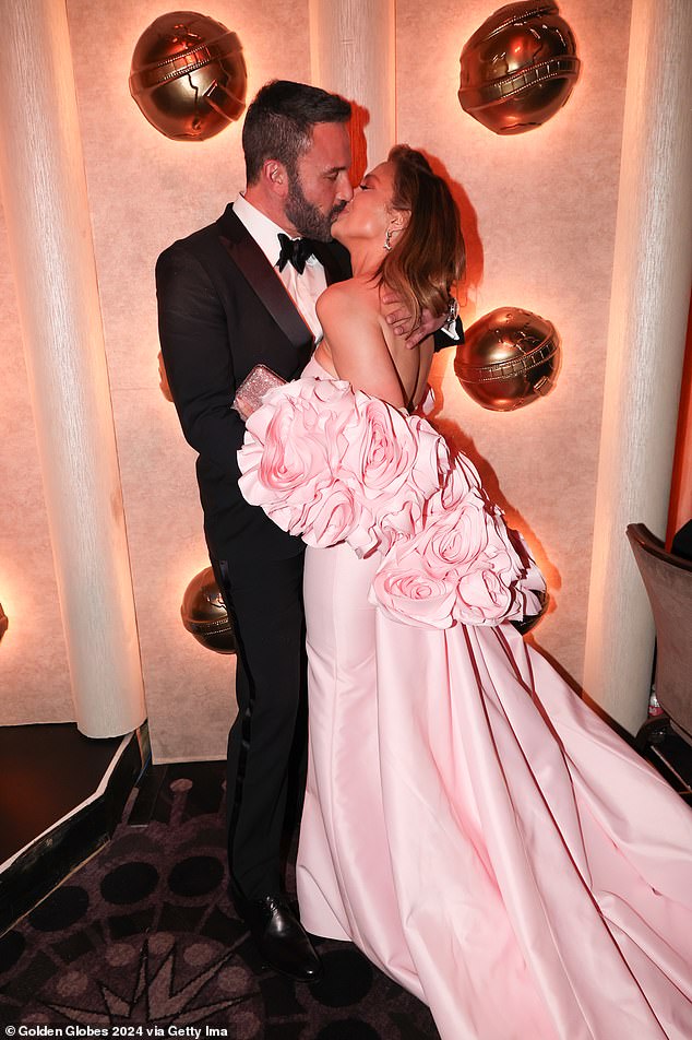 Affleck appeared to indulge his wife's love of being photographed as the couple packed on the PDA at the 2024 Golden Globe Awards on Sunday