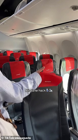 Before she sat down on her Norwegian Airlines flight, she turned the headrest covers of the seats in front of her so that they hung down in the back and faced her.