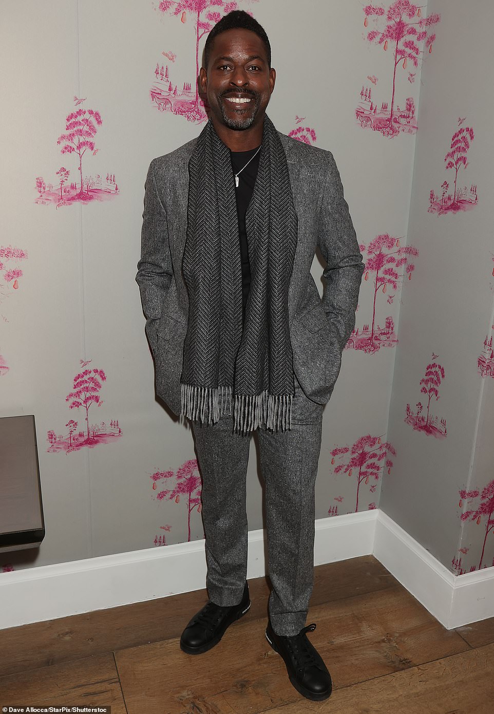 Meanwhile, Brown looked dapper in a gray suit over a black top, a dark gray scarf and black Dolce & Gabbana lace-up shoes, selected by stylist Linda Medvene.