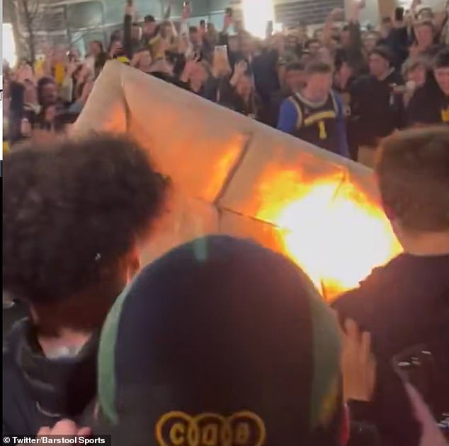 1704784222 556 Michigan fans celebrate national championship victory by lighting benches on