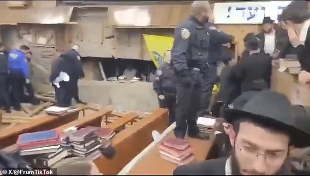 Members of the synagogue on Monday tore away interior wooden panels to reveal the entrance to the tunnel and entered to prevent the tunnels from being filled.