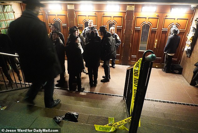 Crowds of Hasidic men lined up outside the building Monday evening