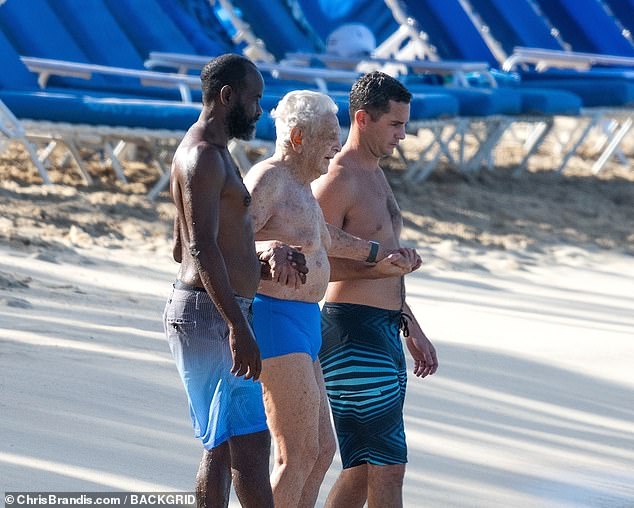 The 93-year-old was led across the beach to the calm waters