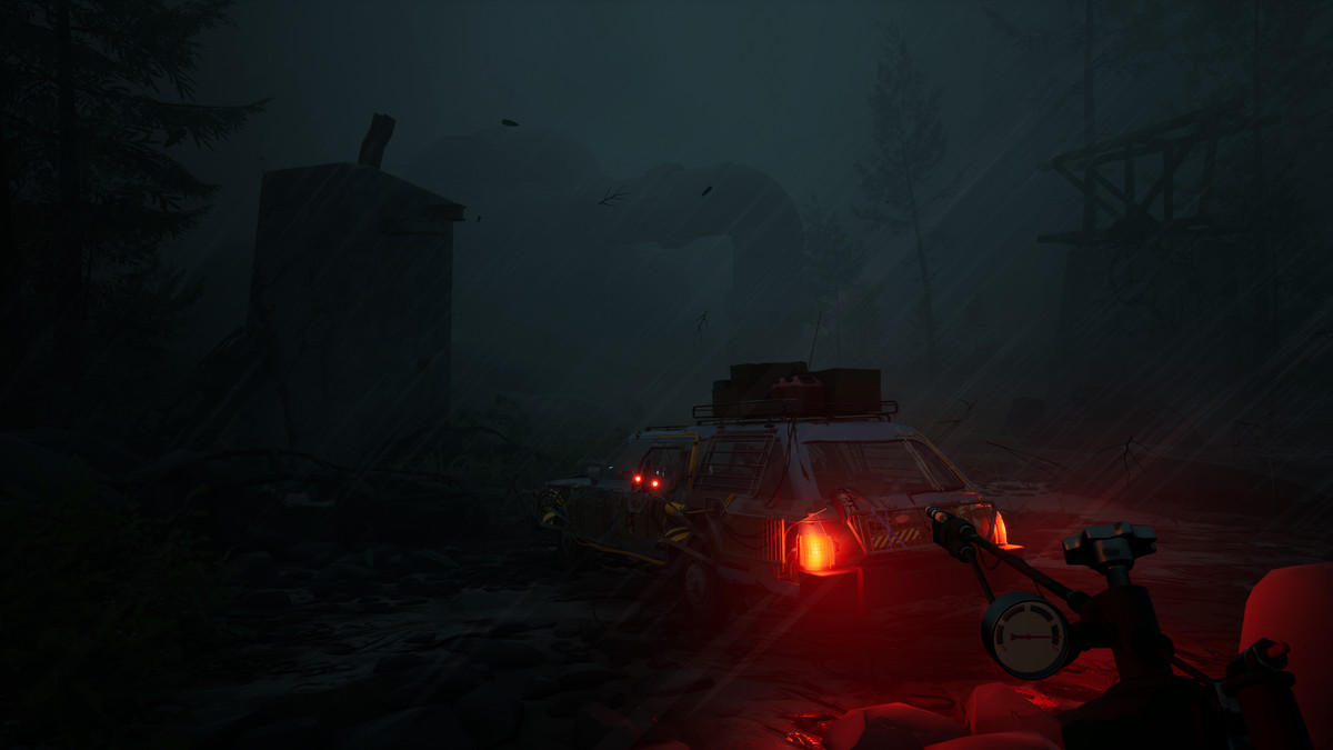 A gloomy, rain-swept nighttime first-person view of a station wagon with lashed-together panels and home-built modifications.  In the foreground the player is holding some kind of mouthpiece