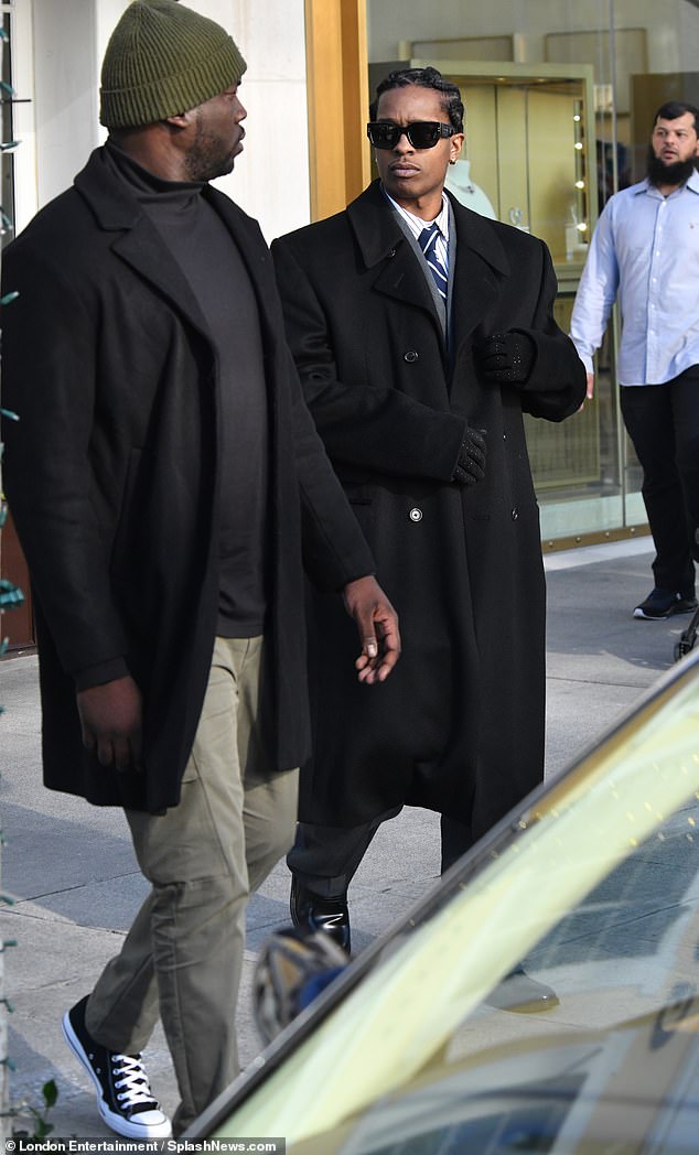 Rocky looked dapper during the outing as he wore a long black double-breasted coat over a charcoal gray suit