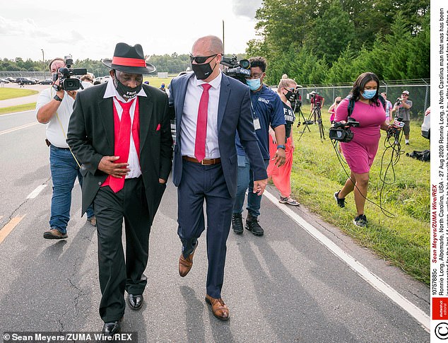 Long (left) is pictured with attorney Jamie Lau (right) on August 27 as he leaves jail after his charges were dropped in U.S. District Court