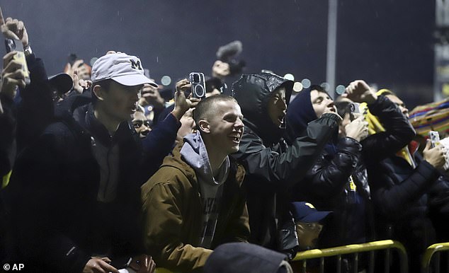 Thousands of fans waited in the rain to welcome the Wolverines from Houston