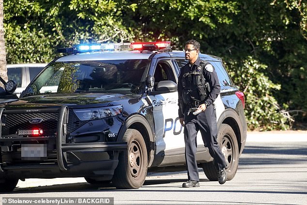 An officer was seen getting out of a police vehicle and walking towards Kendall's parked car