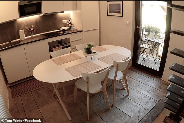 They built a kitchen on the second floor of the house with a beautiful balcony overlooking the historic village and converted the previous kitchen into a living space.