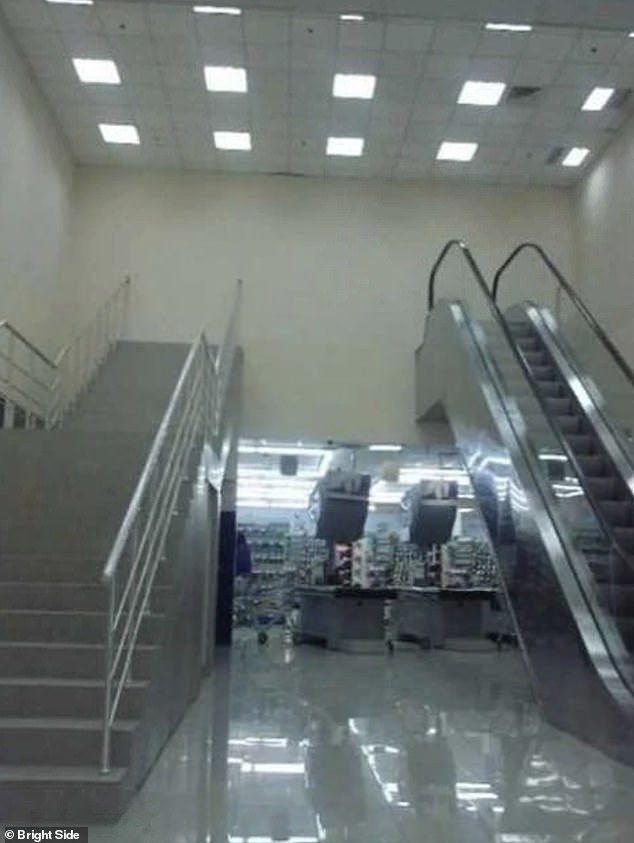 Destination...nowhere!  This photo shows an escalator and stairs that appear to lead directly to a brick wall in a shopping center at an unknown location