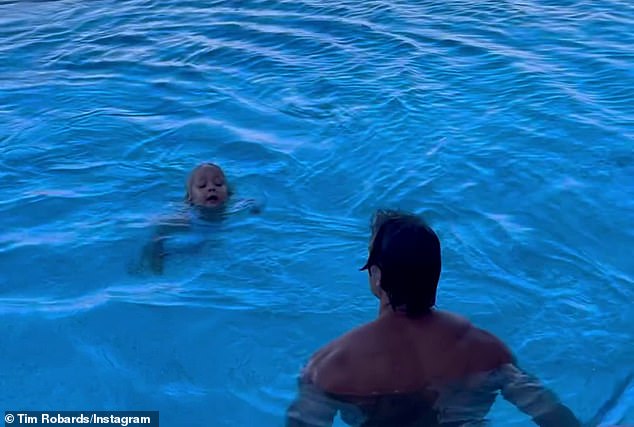The former Bachelor star, 41, showed off his ripped body in just a pair of green speedos, keeping a close eye on his four-year-old as she paddled through the water