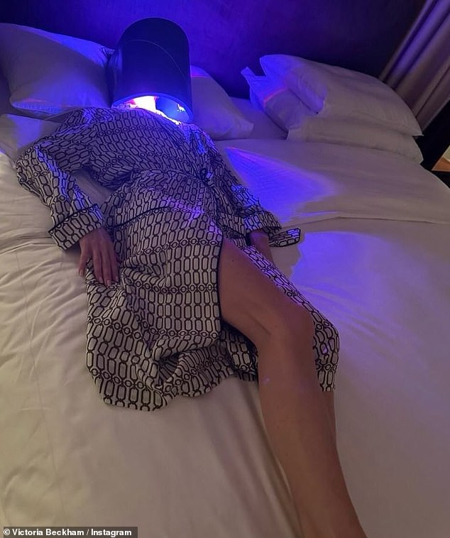 She recently shared a photo of herself wearing a large LED face mask as she lay on her bed in nothing but a £350 bathrobe from her own collection