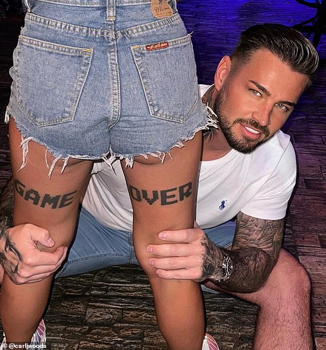 Following the split, Carl took a swipe at her on Monday as he posed hugging a mystery woman's legs, adorned with a tattoo that read 