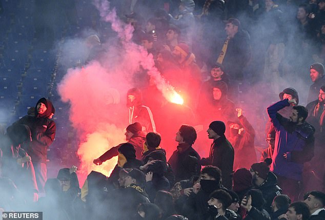 Supporters of the bitter rival fanbases began throwing flares and fireworks at each other