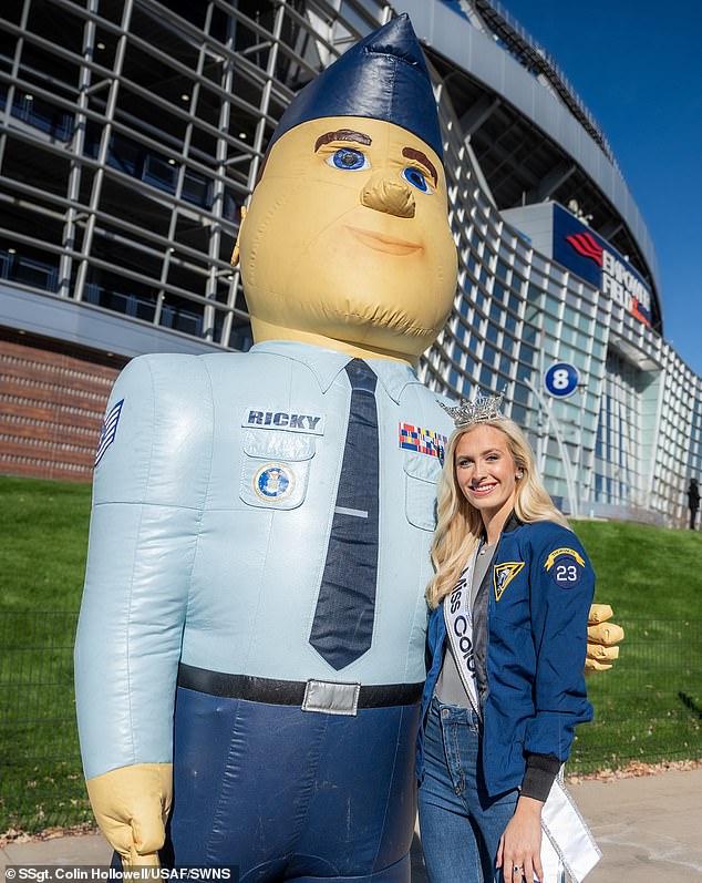 Madison Marsh poses for a photo with Ricky the Recruiter during the USAFA vs.  US Army at Empower Field at Mile High, Denver on November 6, 2023