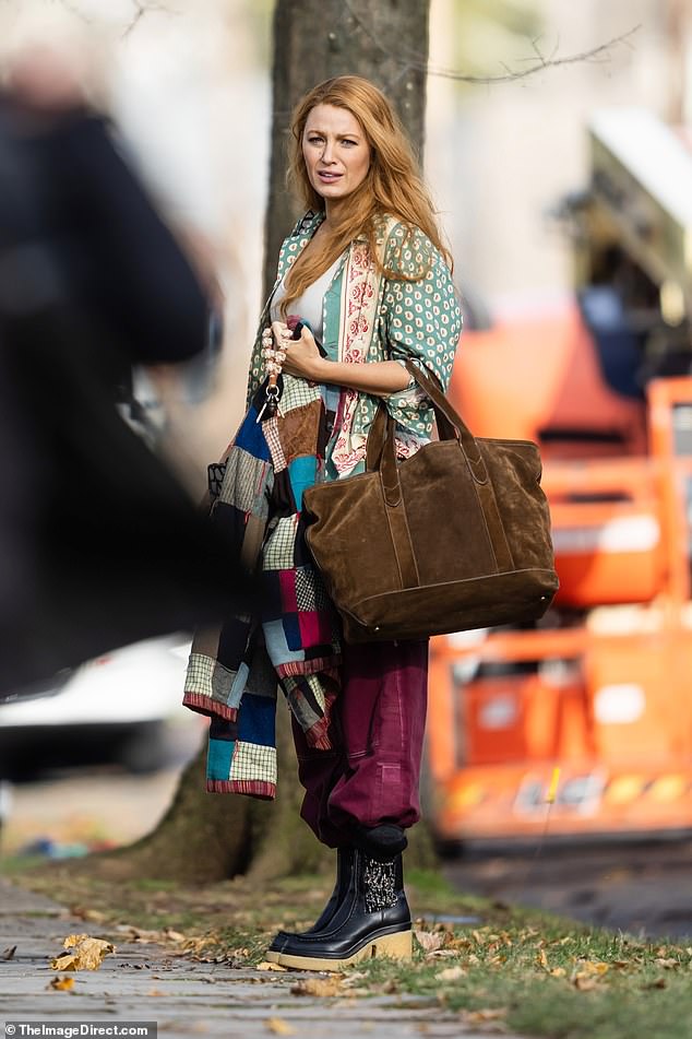 The 36-year-old actress wore an oversized seafoam green, red and white multi-patterned silk top over a clinging white tank top during the outing.