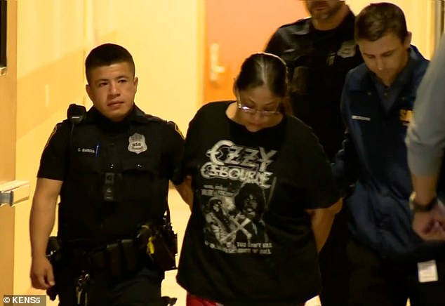 Romanos is walked to a waiting patrol vehicle.  She was charged in connection with the murders of pregnant teen Savanah Soto and her boyfriend Matthew Guerra