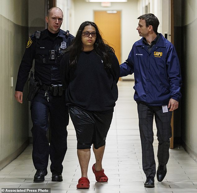 Christopher Preciado, center, was escorted by San Antonio police last Wednesday