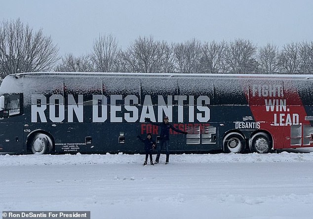 Casey and Mason pose in front of the campaign bus while knocking on doors near Iowa