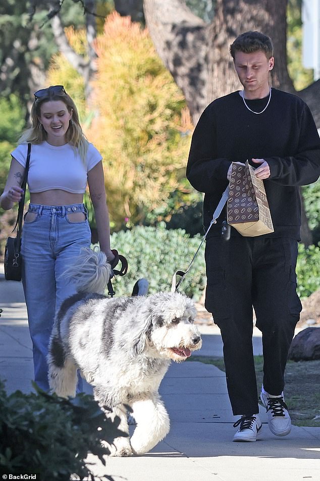 The 24-year-old blonde beauty dressed in a cropped white T-shirt as she and her boyfriend walked their respective dogs