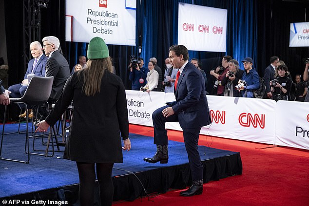 Florida Governor Ron DeSantis' cowboy boots are on display as he appeared in a spin room for an interview on CNN after Wednesday night's Republican debate in Des Moines