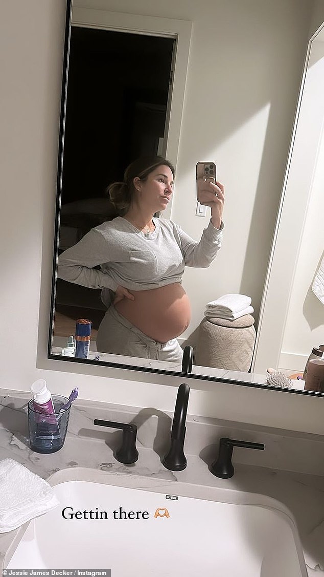 The day before, Jessie took a selfie in a gray loungewear set, lifting her long-sleeved shirt to reveal her burgeoning bump and rolling the waistband of her pants over her.