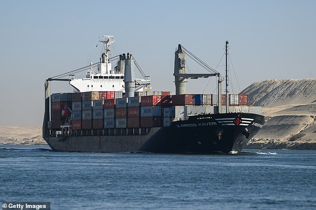 A ship is seen passing through the Suez Canal on Wednesday – a dangerous journey thanks to Houthi bombing