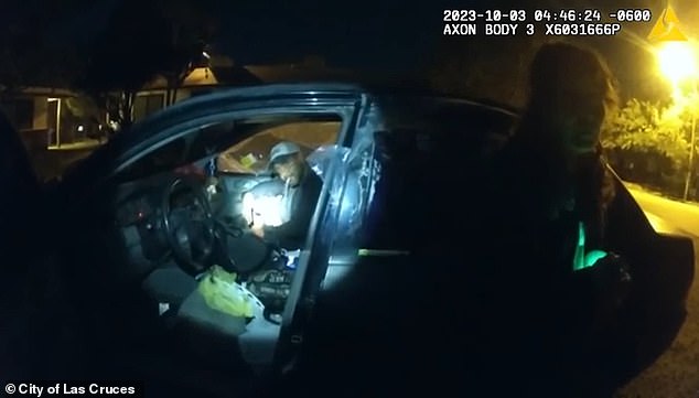 Garcia is seen in the car as Hernandez shines the light on him.  The officer said the passenger knew he was not allowed in the area, violating the judge's orders