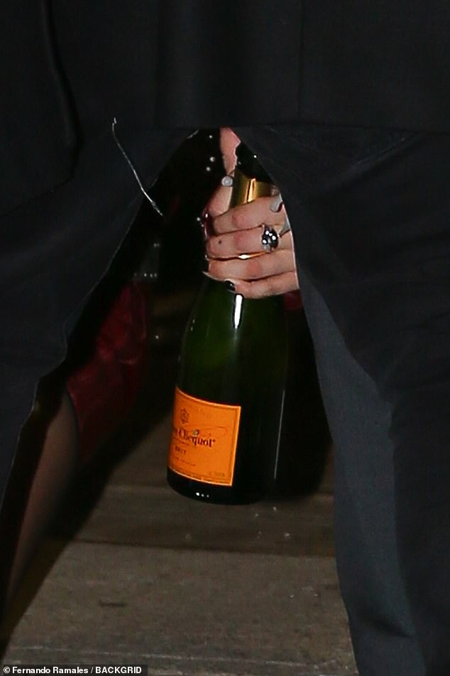 It looked like she was carrying a bottle of Veuve Clicquot