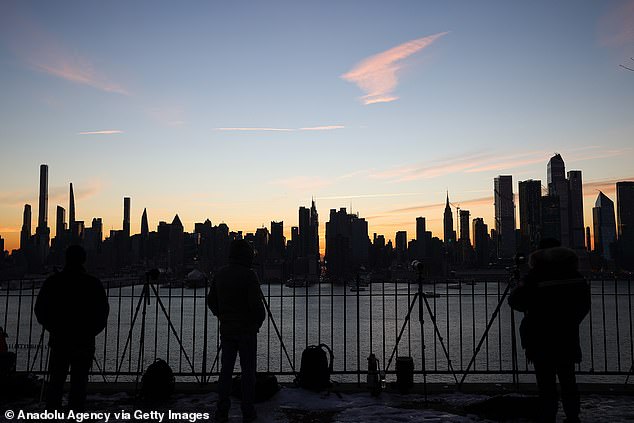 A view of Manhattan as photographers wait for the inverted Manhattanhenge during sunrise from Weehawken in New Jersey, United States on January 12, 2022