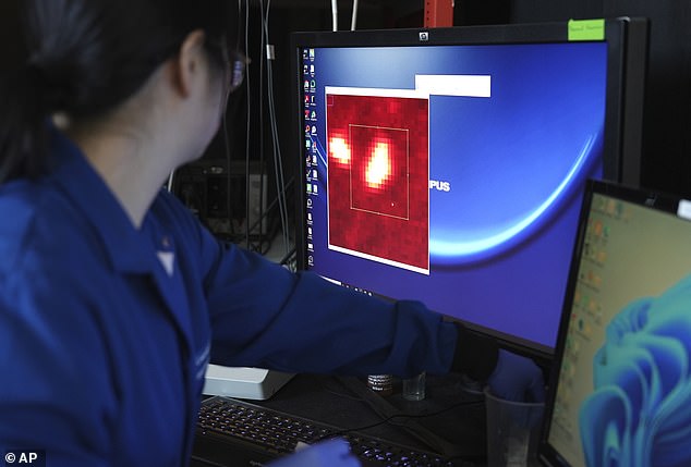 Researchers at Columbia University found that the average liter bottle of water they buy at the store contains more than 240,000 nanoplastics, small molecules linked to cancer, infertility and birth defects.  Pictured is a researcher looking at a nanoparticle