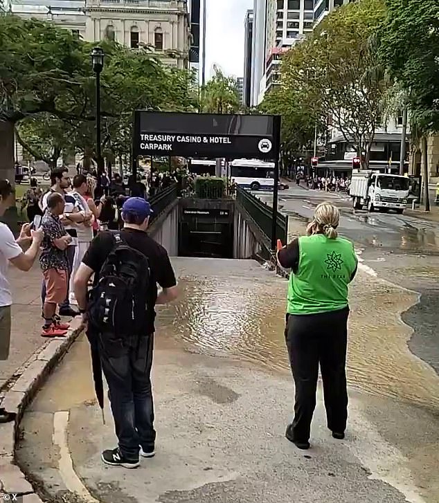 Water is flowing through the car park under the Brisbane Casino and the Oaks Hotel is underwater