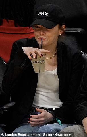 She smiled as she held the drink, still excited by the Phoenix Suns' fantastic performance away from home