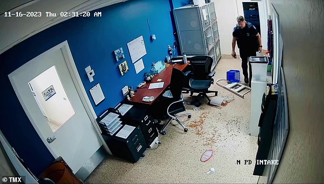 When the officer saw the mess, he started cleaning up and even grabbed a broom and dustpan to sweep up the dog food.