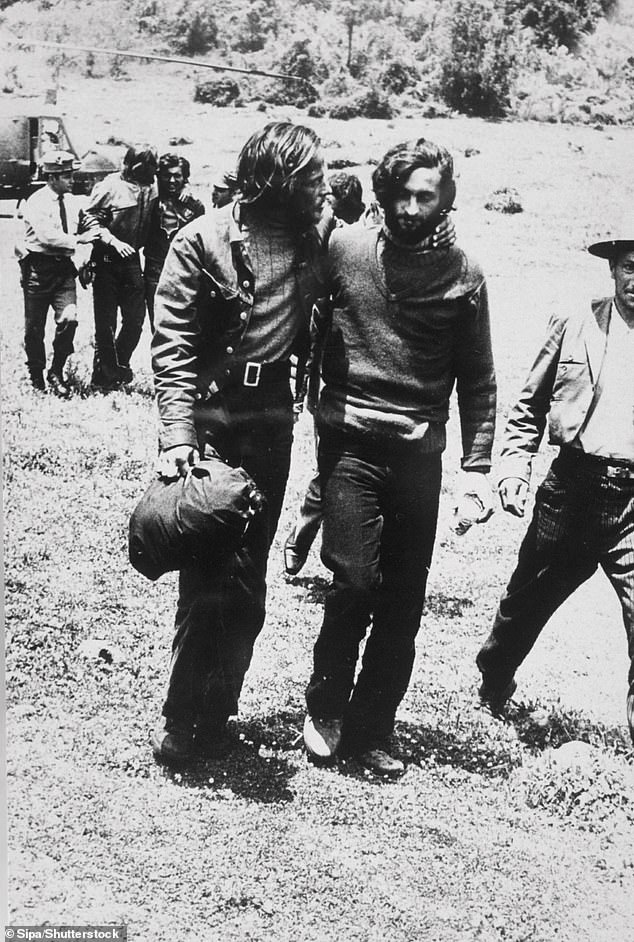 A rescue worker assists one of the survivors.  The passengers were stranded in the snow in the Andes for 72 days