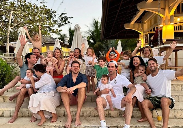 Everyone says cheese!  The twenty-member group of friends and their children pose on the steps of a Jamaican seaside resort.  August can be seen standing and waving in a green t-shirt